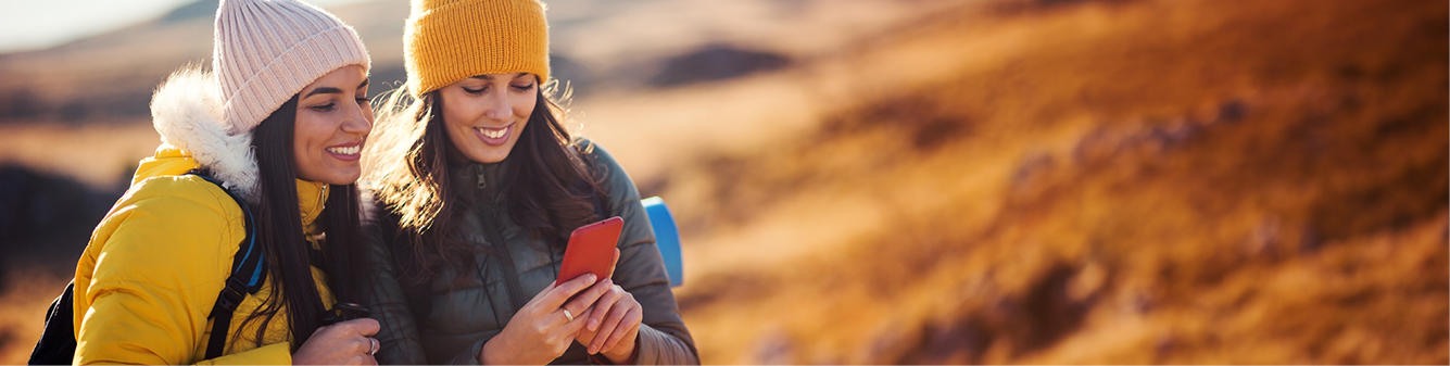 businesswoman walking on city modern building using smartphone online